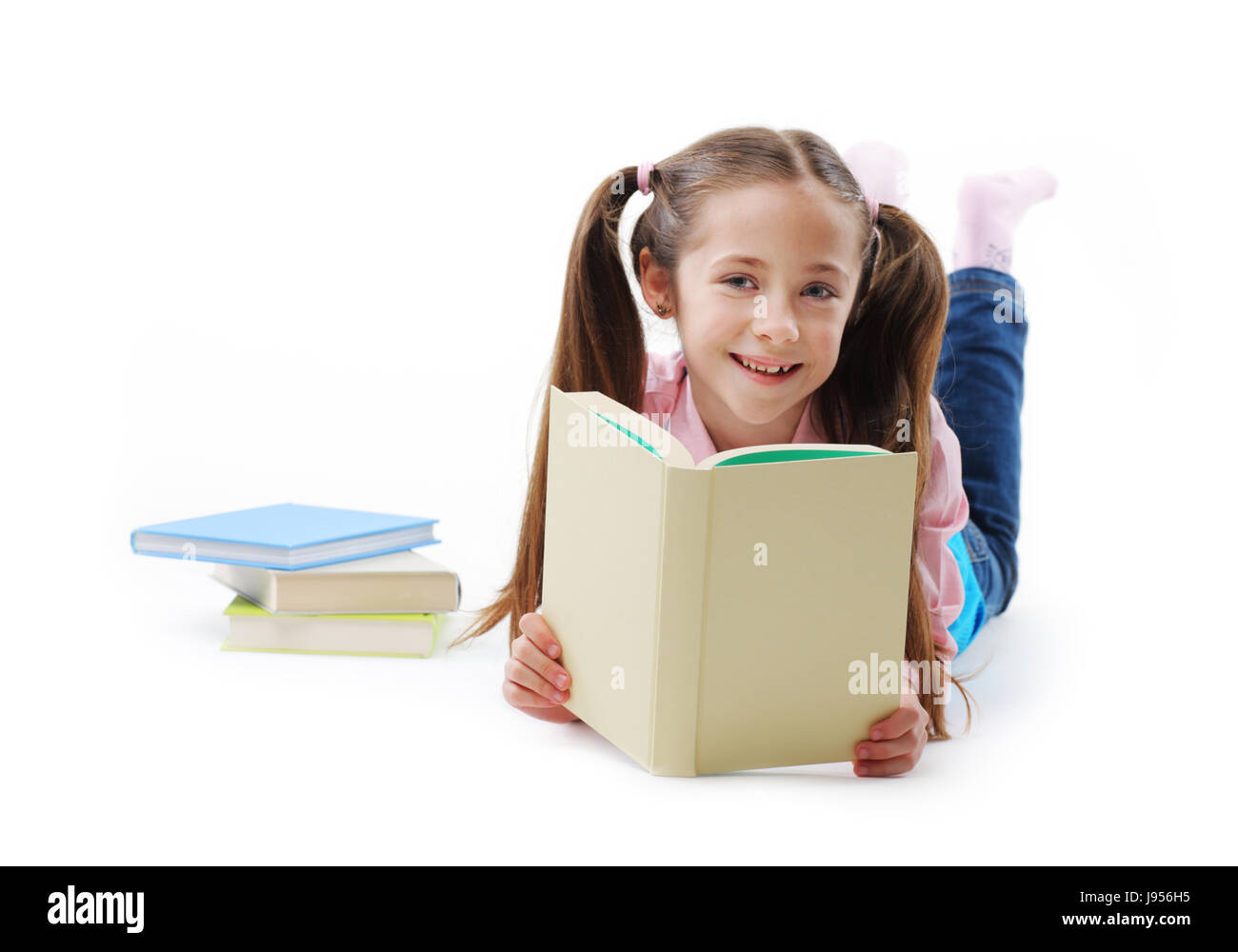 Schoolgirl with book on white background Stock Photo - Alamy