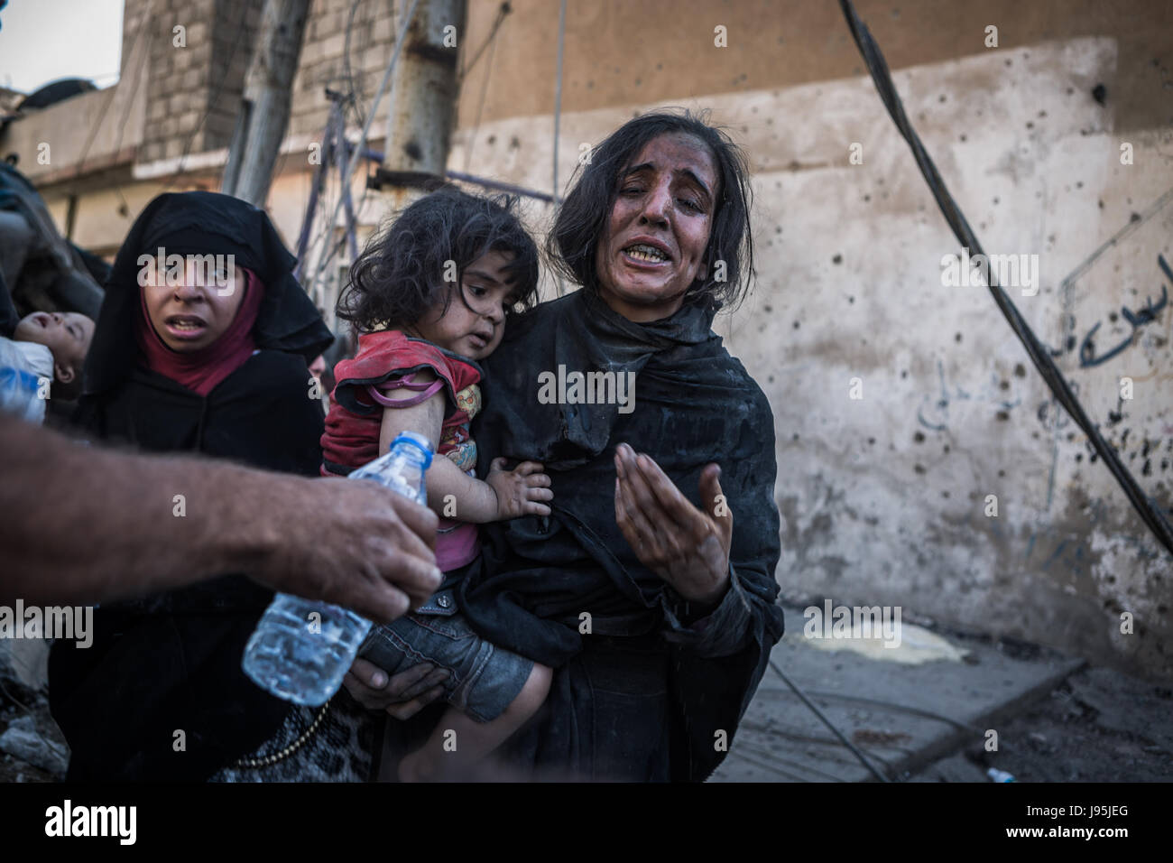 Civilians flee heavy fighting between the Iraqi army and terrorist group Islamic State (IS) in Al-Zinjili, west Mosul, Iraq, 4 June 2017. Photo: Andrea DiCenzo/dpa Stock Photo