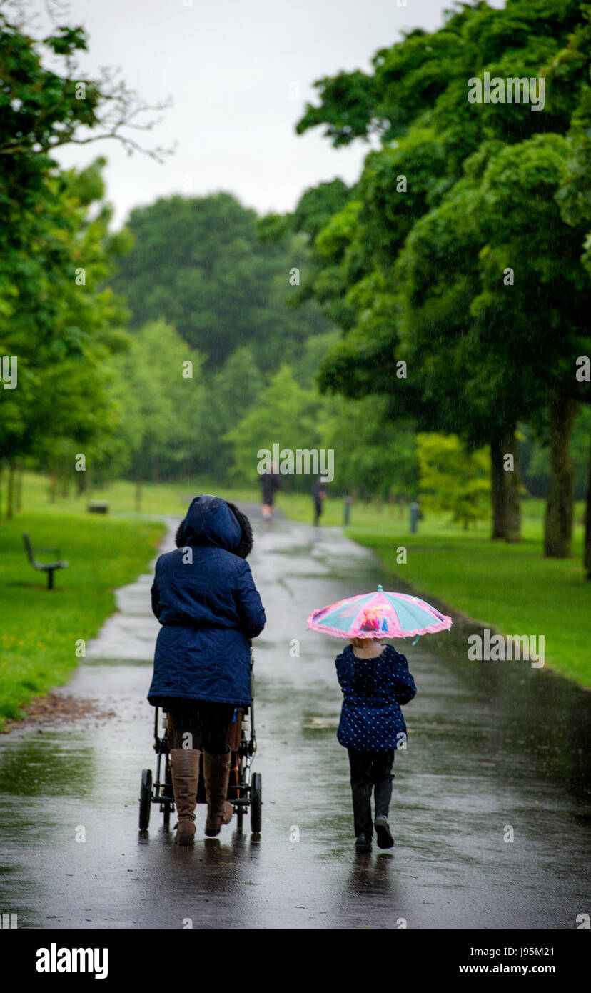 Bolton, Lancashire, UK. 05th June, 2017. Very soggy walk to school after the half term holidays in Leverhulme Park, Bolton, Lancashire, UK. Torrential rain lashes the North West of England at the start of June. Picture by Paul Heyes, Monday June 05, 2017. Credit: Paul Heyes/Alamy Live News Stock Photo