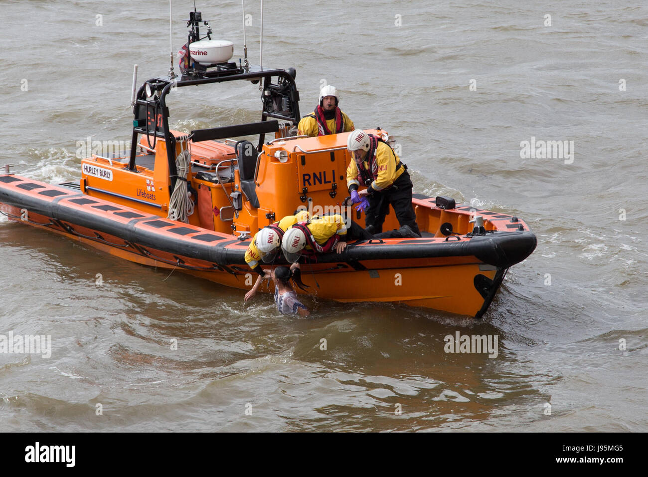 Westminster, London, UK. 5th June, 2017. RNLI crew from the Tower Lifeboat station pull a woman from the River Thames by Westminster Bridge by the Houses of Parliament. The woman was recovered safely from the water. A passing tourist told police she smoked a cigarette, uttered something and then deliberately jumped. She is the fourth person to have jumped off Westminster Bridge after the terrorist attack there on 22 March 2017. Credit: On Sight Photographic/Alamy Live News Stock Photo