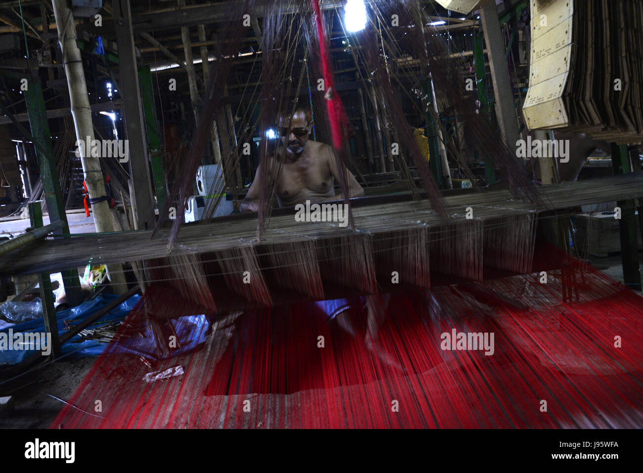 Dhaka, Bangladesh. 4th Jun, 2017. A Bangladeshi weaver weaves Benarasi sari (Woman Wear) on a traditional wooden hand weaving loom at Mirpur in Dhaka, Bangladesh. On June 04, 2017 Benarasi Sari has an ancient history beginning from the Mughal Empire in the 16th century. It is known that it originated from Benaras, a northern city of India. Benarasi Sari found its way to Bangladesh, when the Muslims migrated from Benaras into Bangladesh. Credit: Mamunur Rashid/Alamy Live News Stock Photo