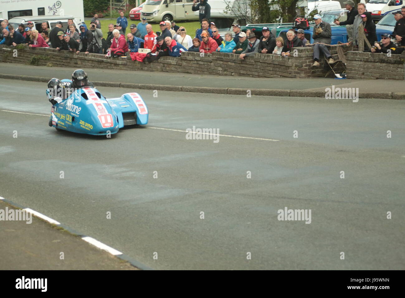 Ramsey, UK. 5th Jun, 2017. Isle of Man TT Races, Sure Sidecar Race. Number 11, Tony Baker and Fiona Baker-Holden on their 600cc Baker Suzuki sidecar from the Silicone Engineering and Carl Cox Motorsport team at Cruickshanks Corner, Ramsey, Isle of Man. Credit: Louisa Jane Bawden/Alamy Live News. Stock Photo
