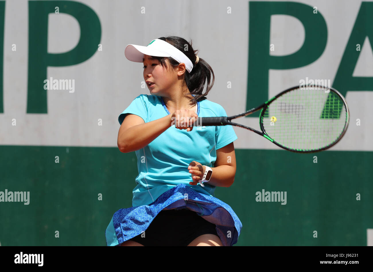 Japanese junior tennis player Yuki Naito is in action during her 1st round  match at the Girls singles French Open in Roland Garros Stadium vs French  junior tennis player Yasmine Mansouri on
