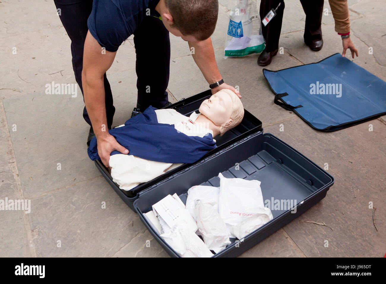 Man putting away CPR manikin in its case (aka Rescue Anne, Resusci Annie, CPR Annie) - USA Stock Photo