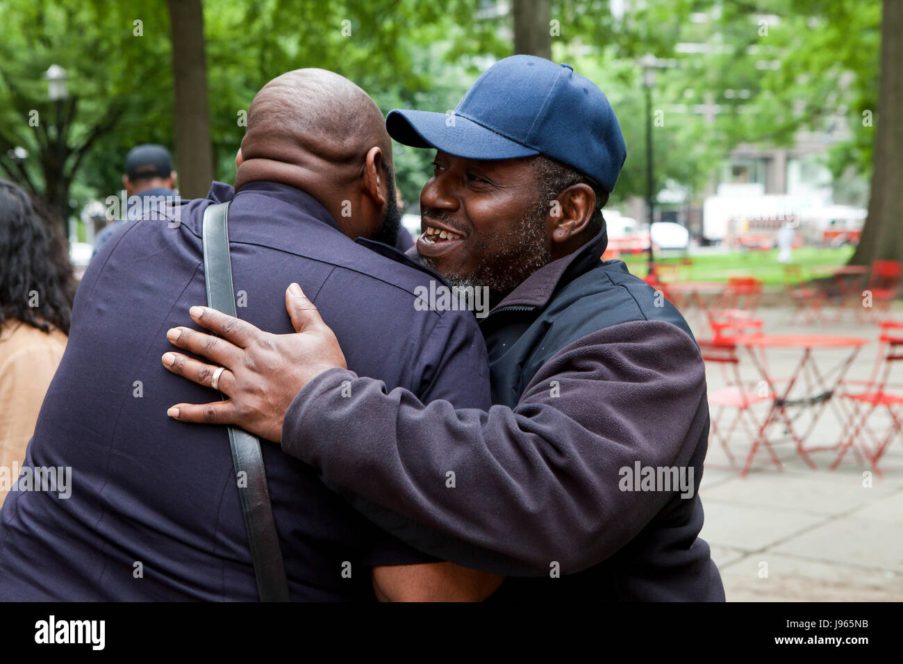 African-American men giving each other a 'man hug' - USA Stock Photo