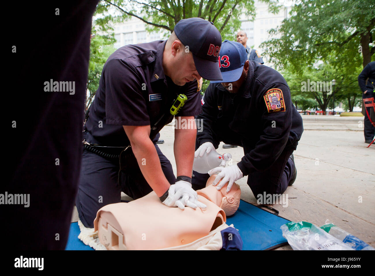 Fire and EMS technicians (EMT, Paramedic) performing CPR on CPR manikin (CPR training) - Washington, DC USA Stock Photo