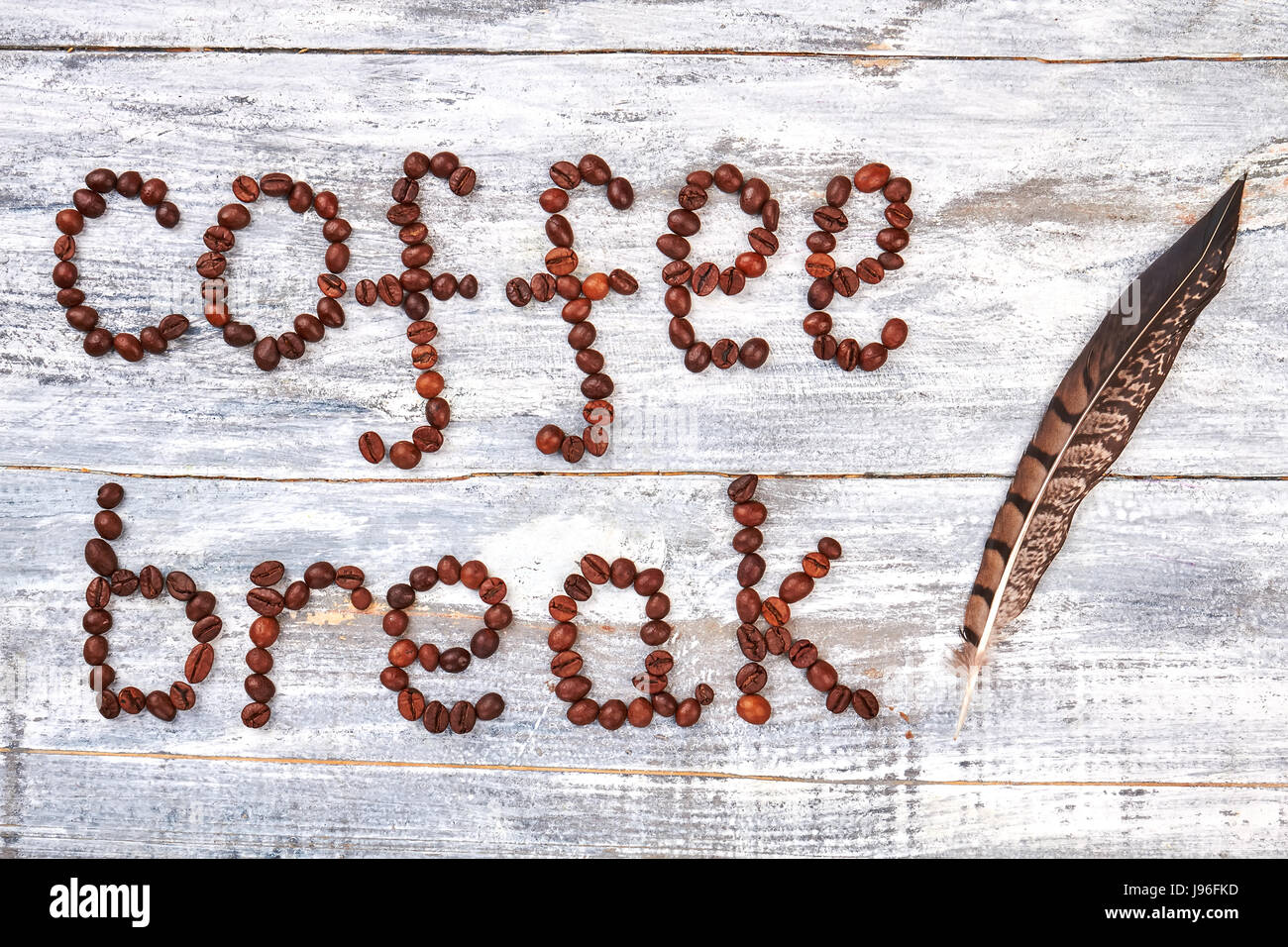 Coffee bean and feather. Stock Photo