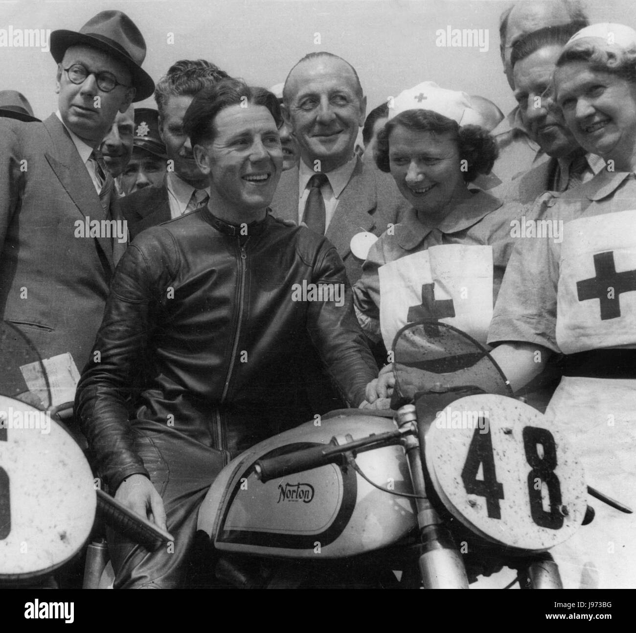 Geoff Duke astride his Norton motorcycle after winning race Stock Photo
