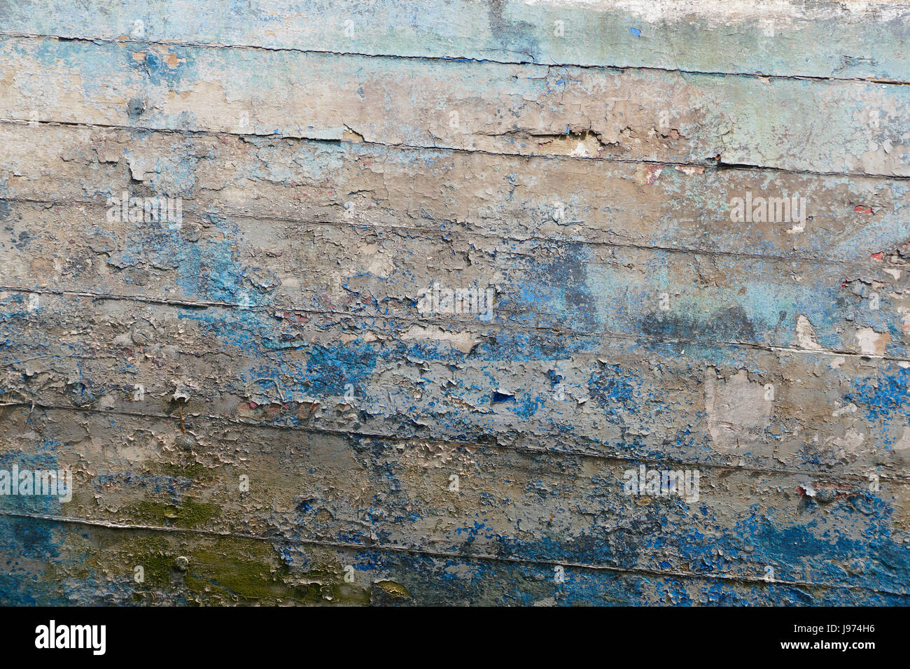 Paint faded on an old wooden boat hull in MinihicsurRance (Rance