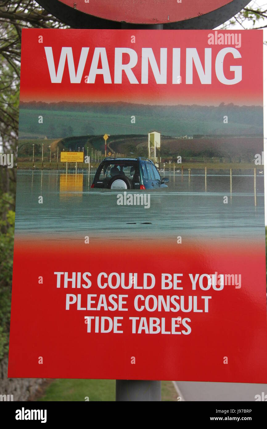 Warning sign for Lindisfarne tides Stock Photo Alamy