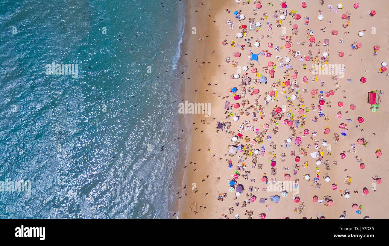 Tropical beach with colorful umbrellas - Top down aerial view Stock Photo