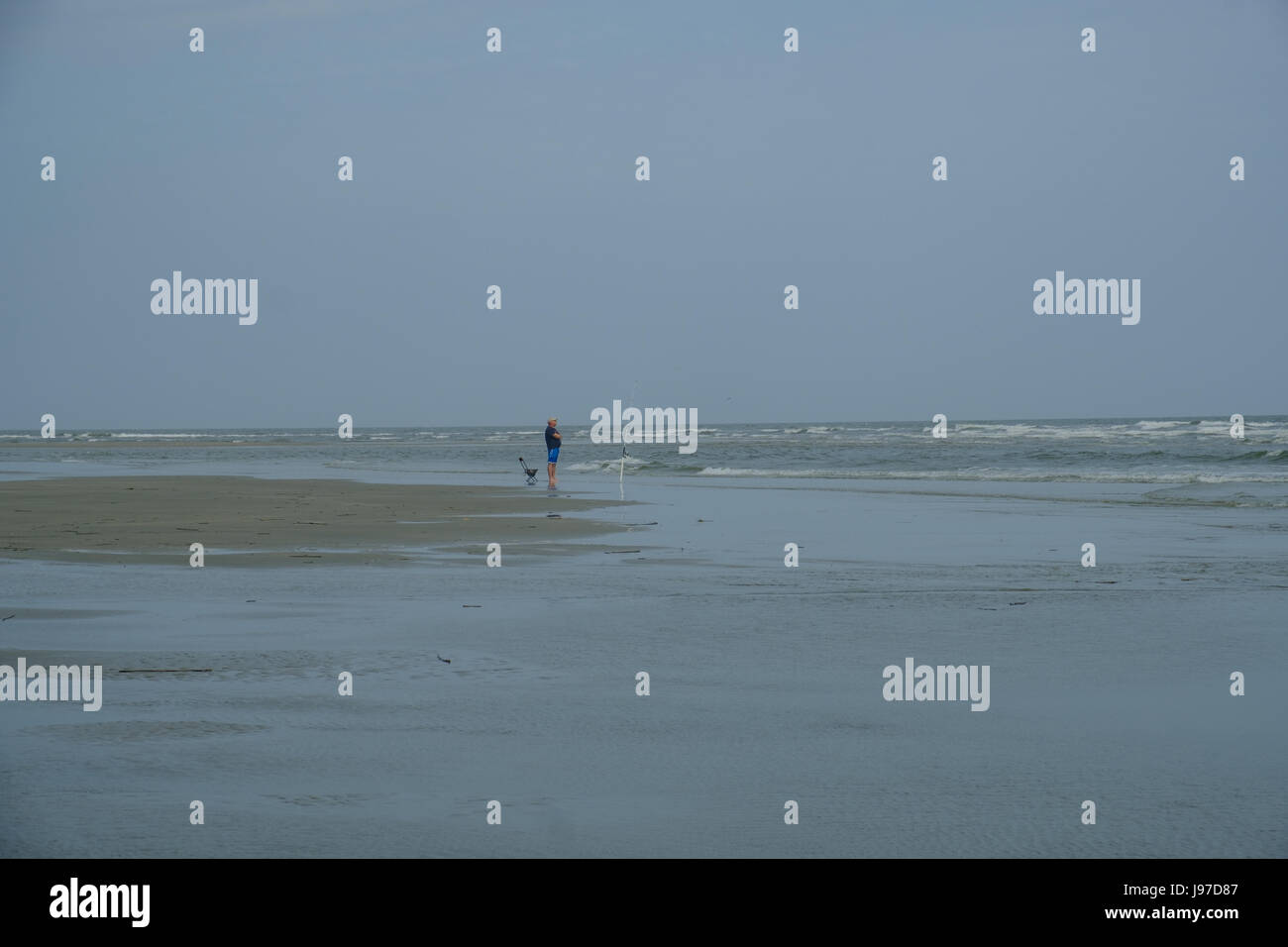 Lone Fisherman on the Beach Stock Photo