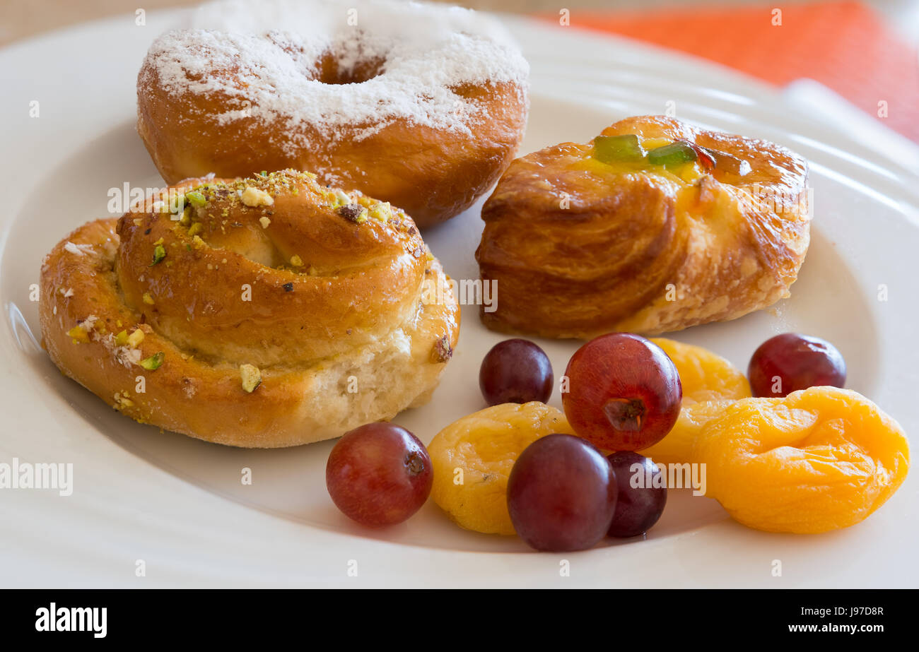 Danish pastry and  fruits on white dish,close-up. Stock Photo