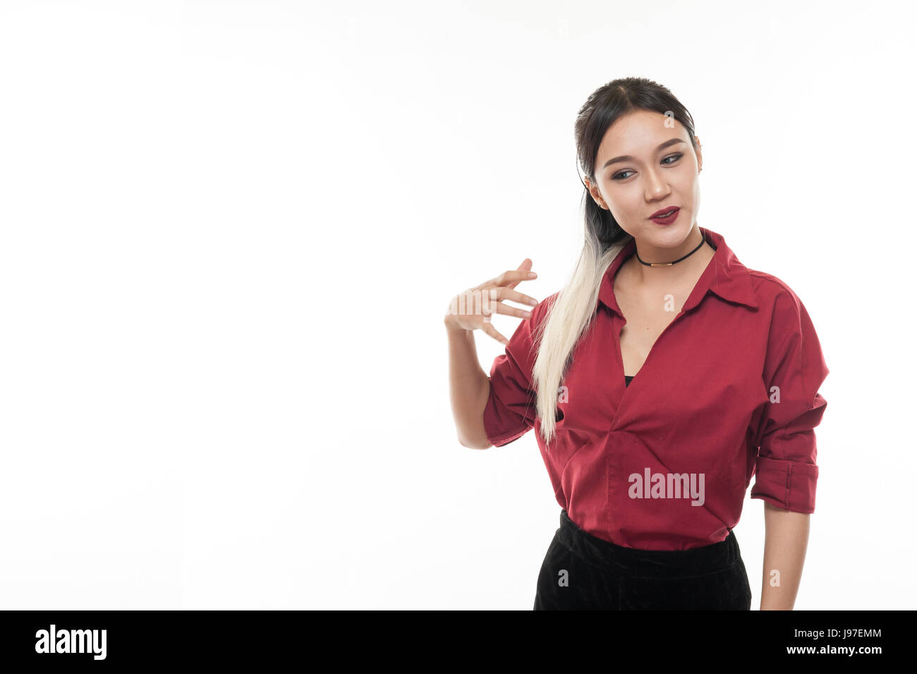 Young attractive tan skin Asian woman wear red shirt in good feeling action. Studio scene of woman with positive emotion with copy space Stock Photo