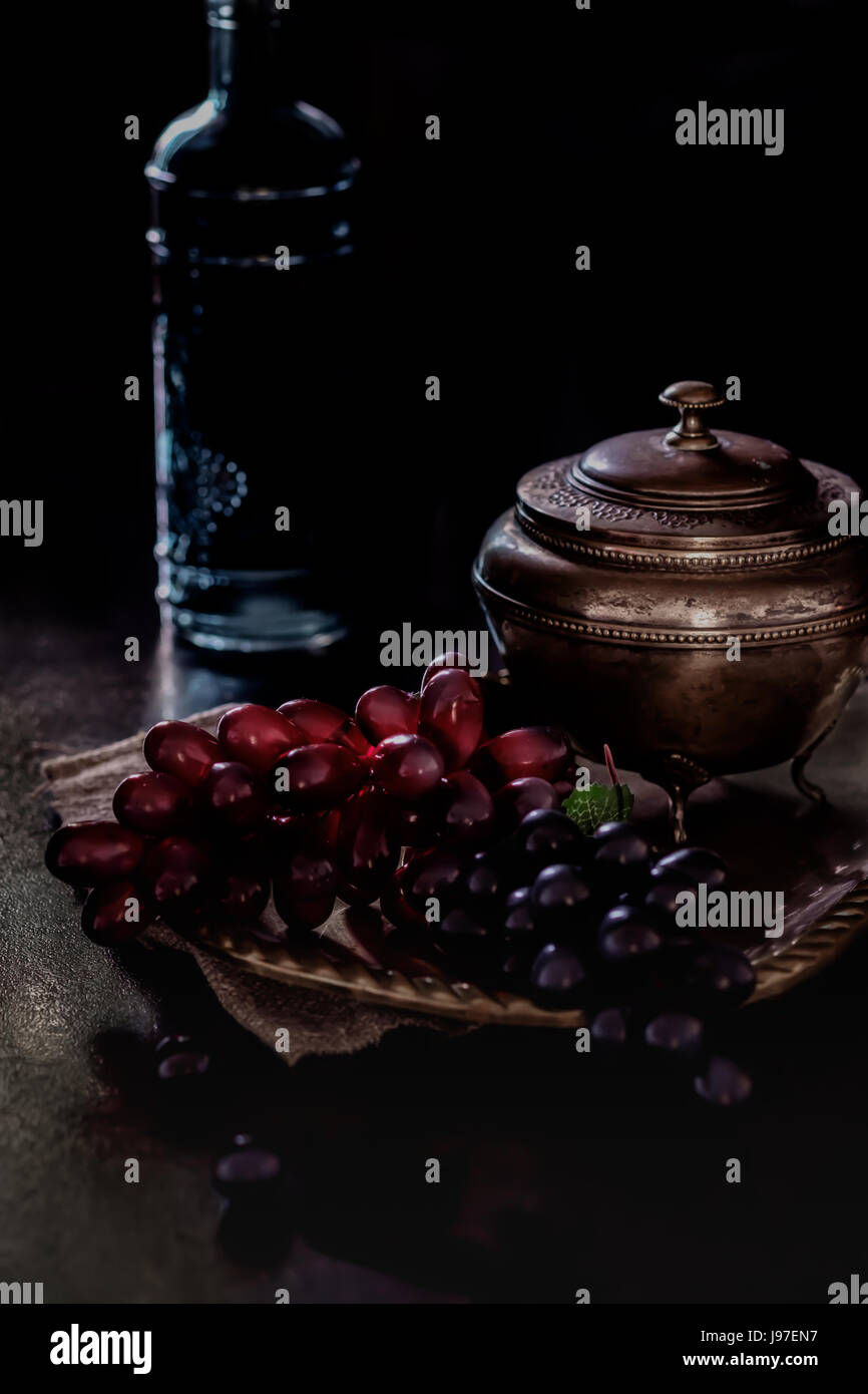 Still life with grapes and bottle in moon light Stock Photo