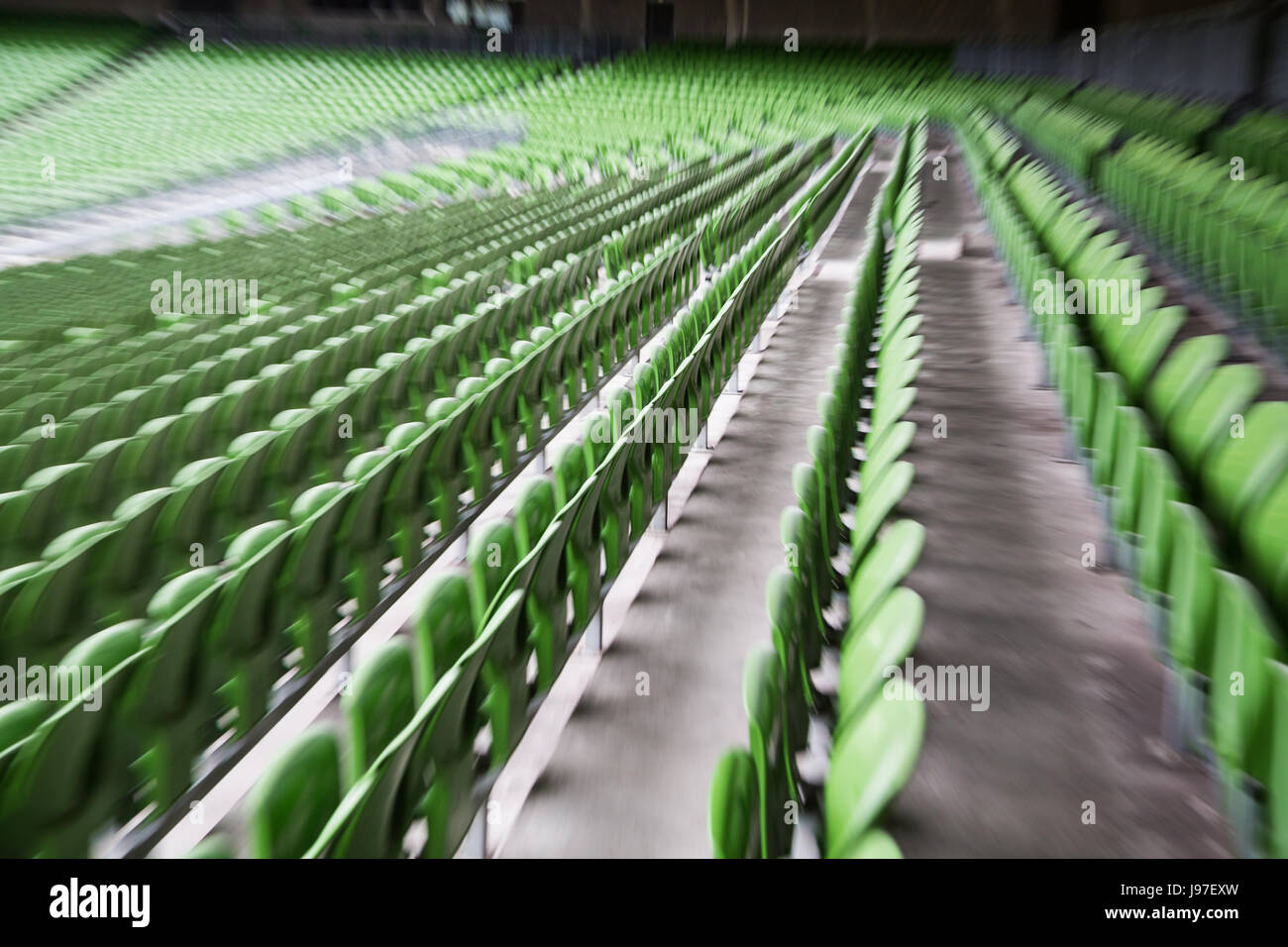 A row of empty green seats in a football stadium Stock Photo