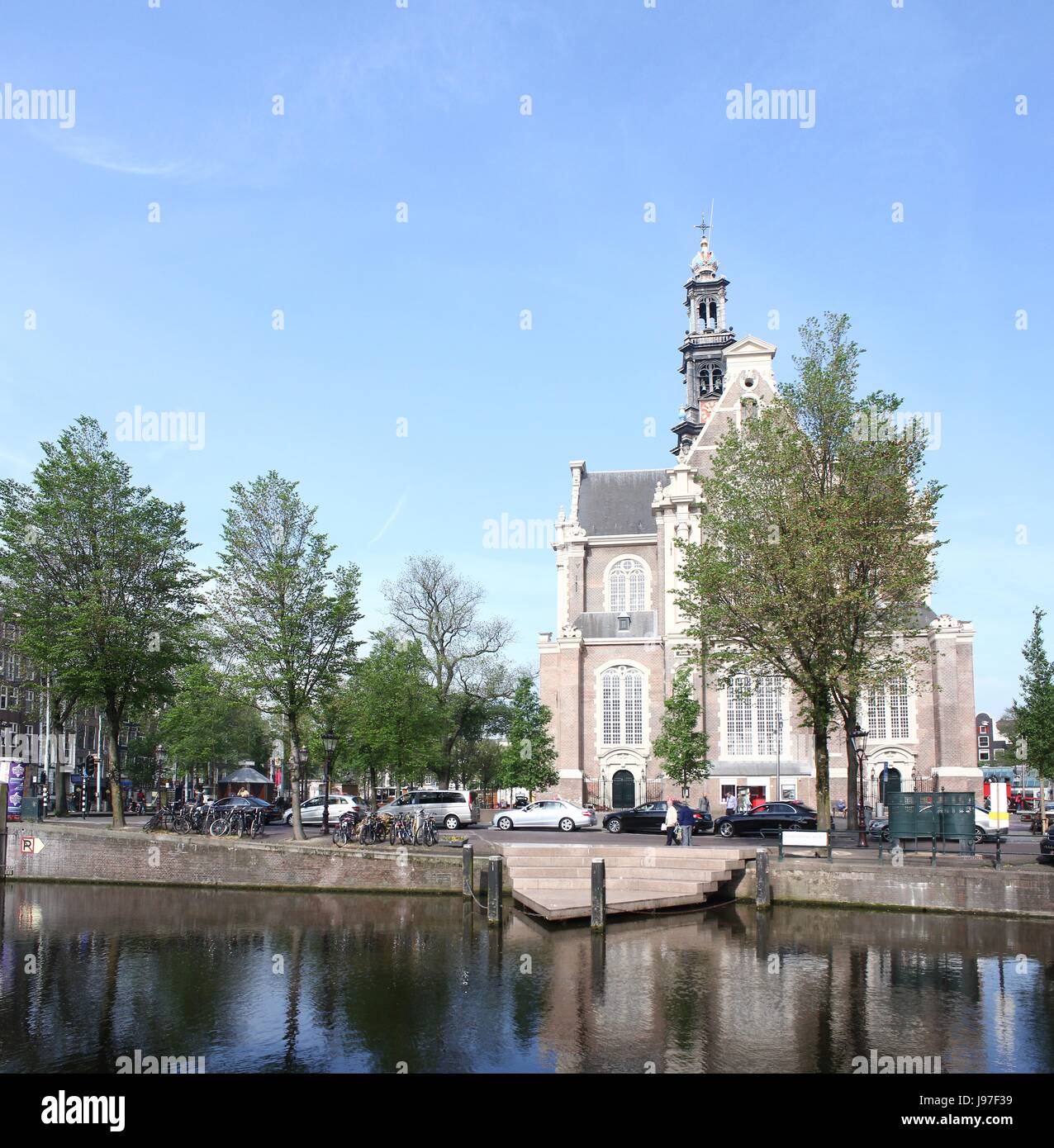 17th century Westerkerk, Protestant church, Amsterdam Jordaan district, Keizersgracht canal, Netherlands. Homo monument on the canal bank in front. Stock Photo