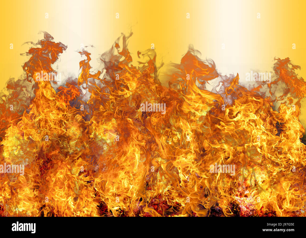 Beautiful stylish fire flames, isolated against the golden colored background Stock Photo