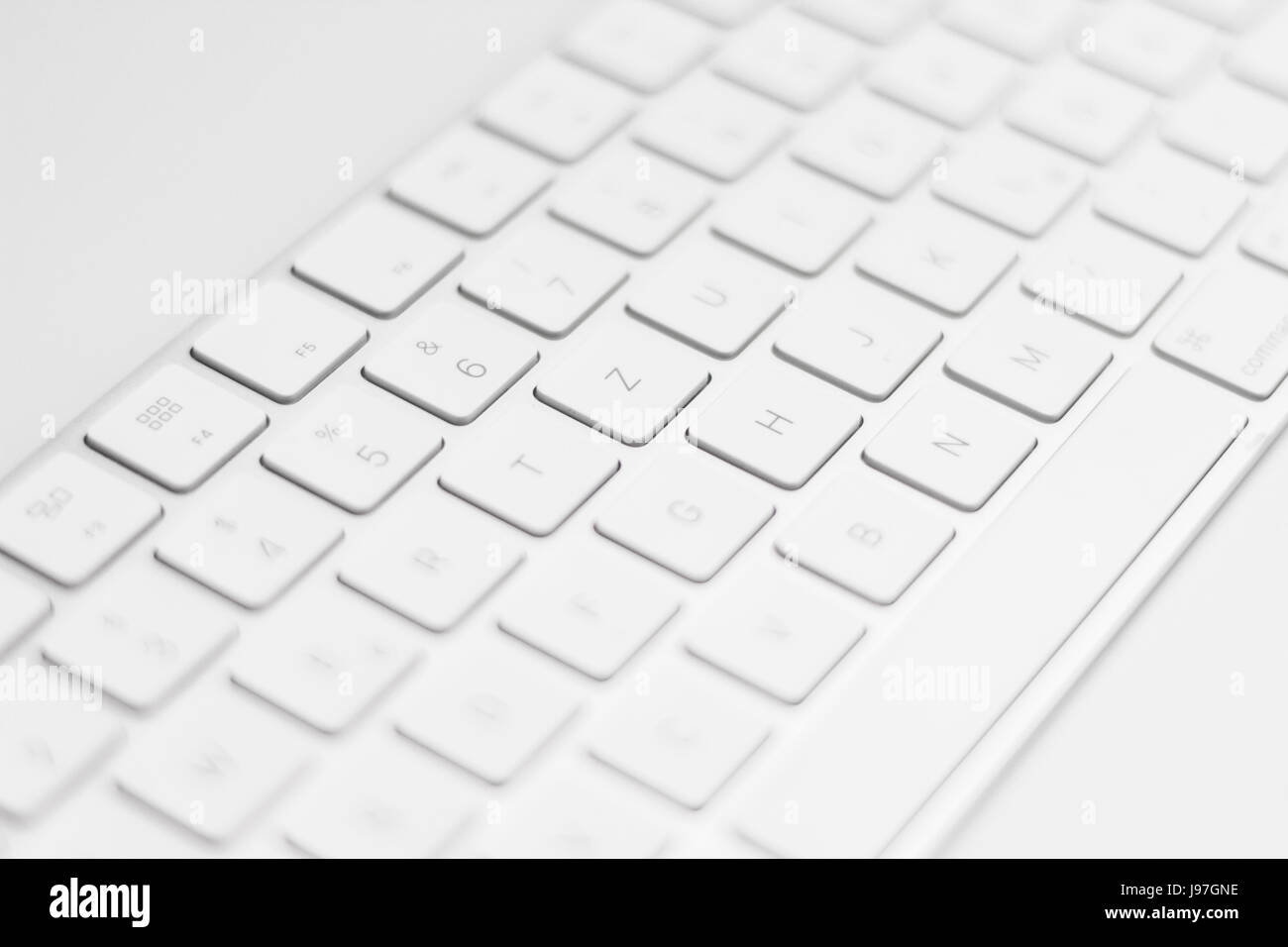 closeup of a modern white, silver keyboard macro Stock Photo