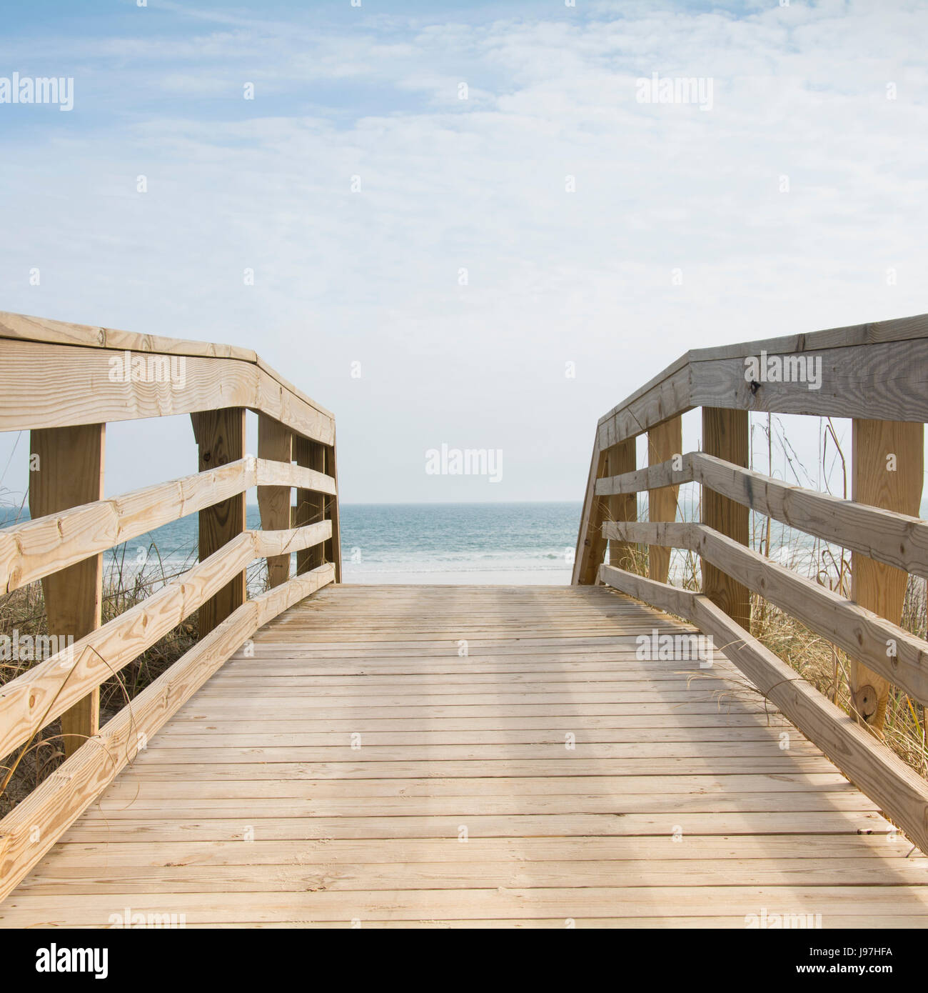 Wooden boardwalk by sea Stock Photo Alamy
