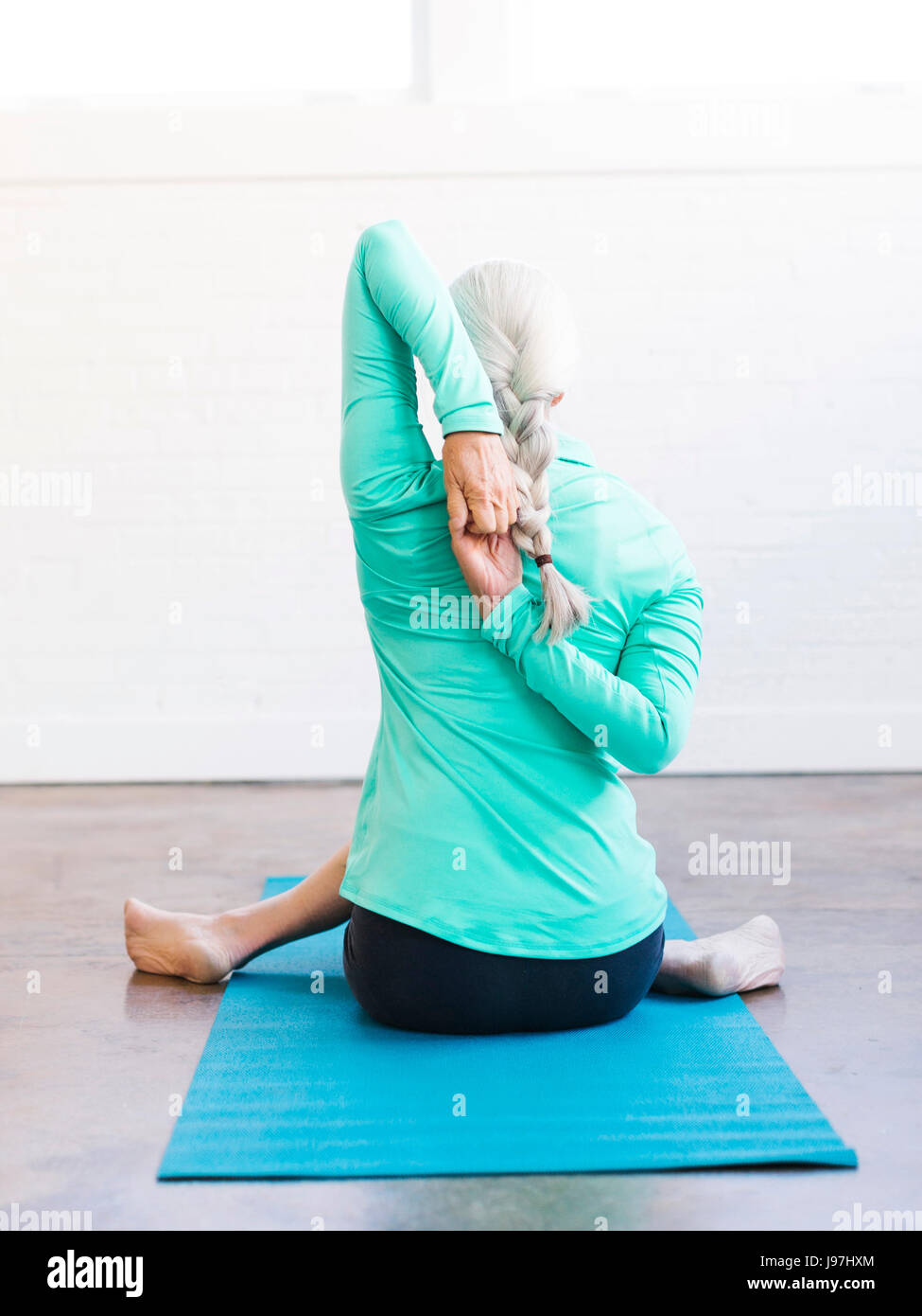 Senior woman yoga rear view hi-res stock photography and images - Alamy