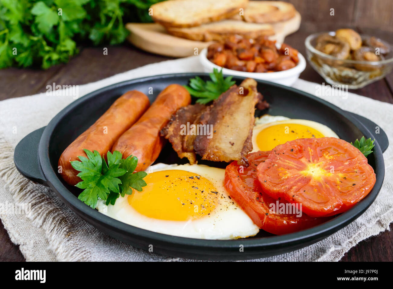 English breakfast sausages, bacon, tomatoes, egg, beans in sauce