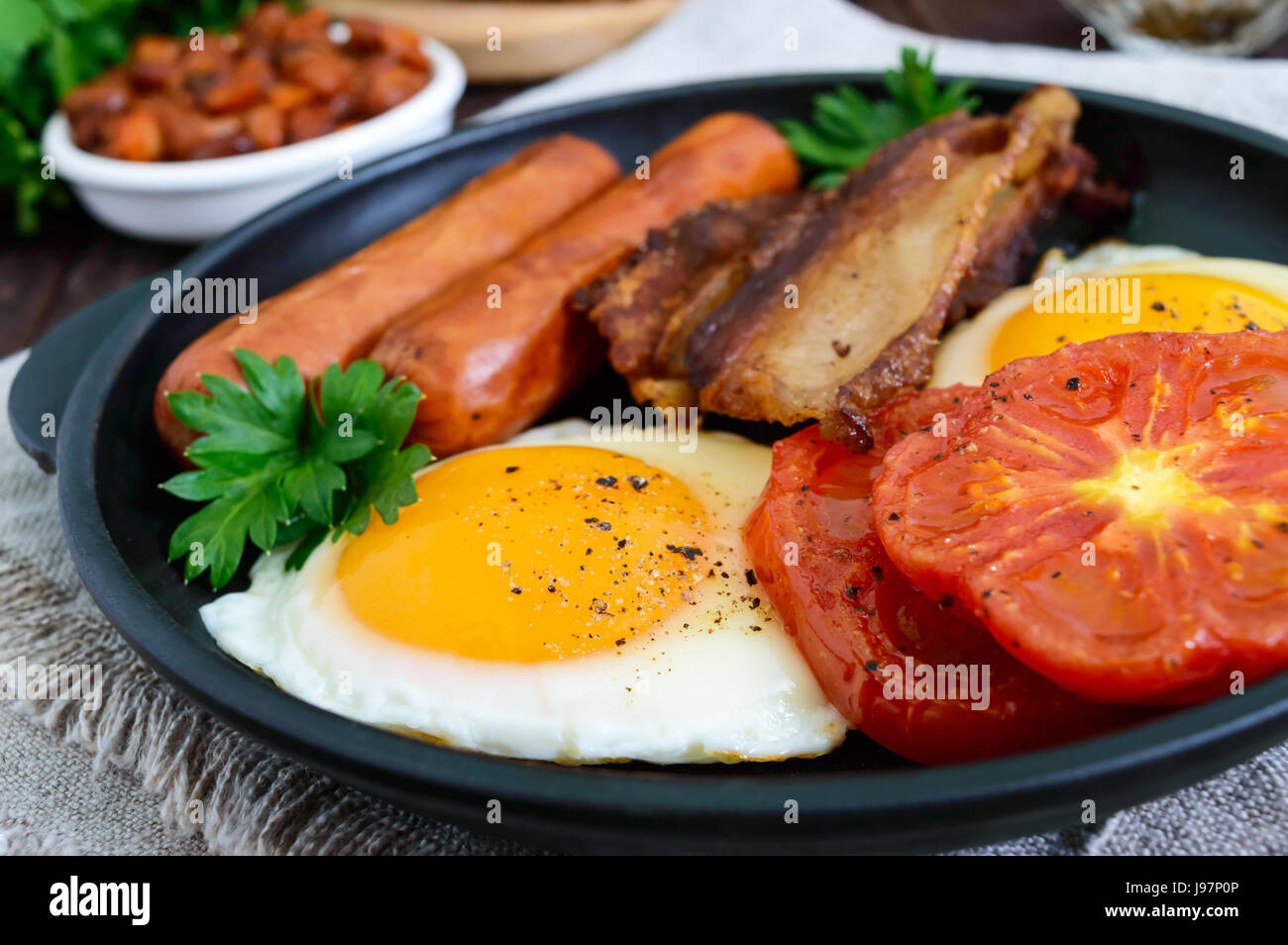 English breakfast sausages, bacon, tomatoes, egg, beans in sauce