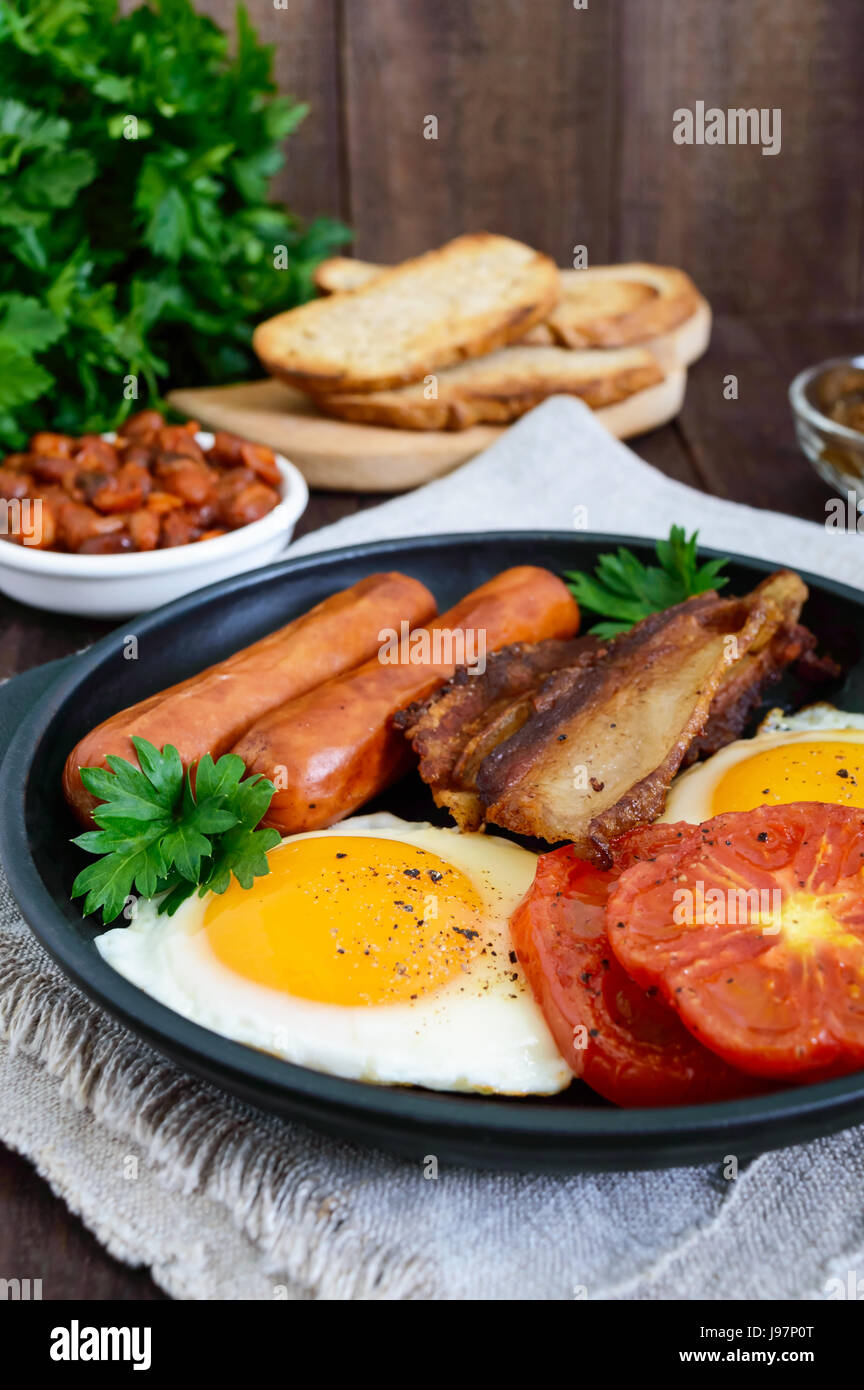 English breakfast sausages, bacon, tomatoes, egg, beans in sauce