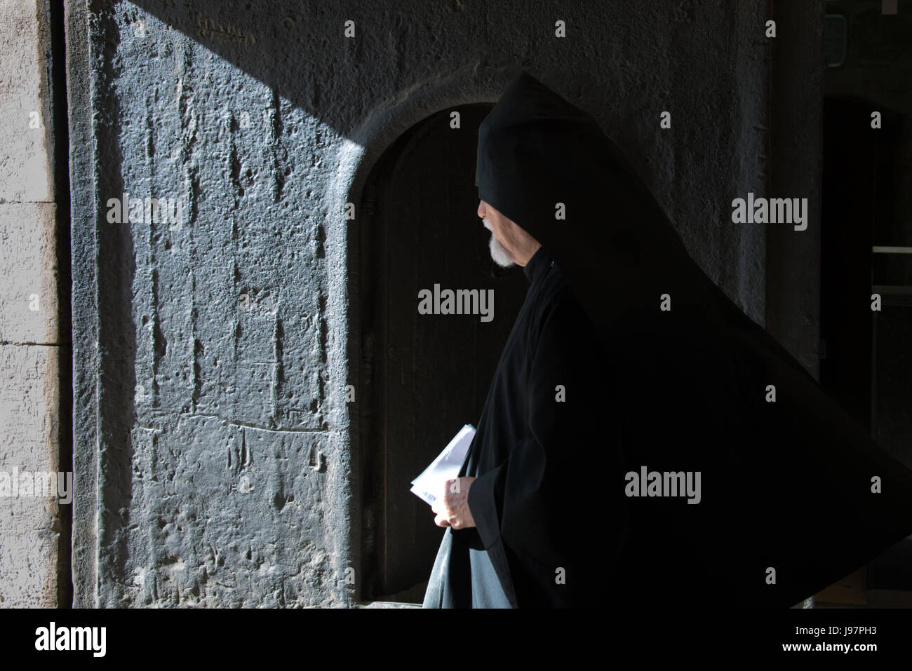 An Armenian orthodox priest exits the Cathedral of St. James, Old City of Jerusalem, April 17, 2014. Stock Photo