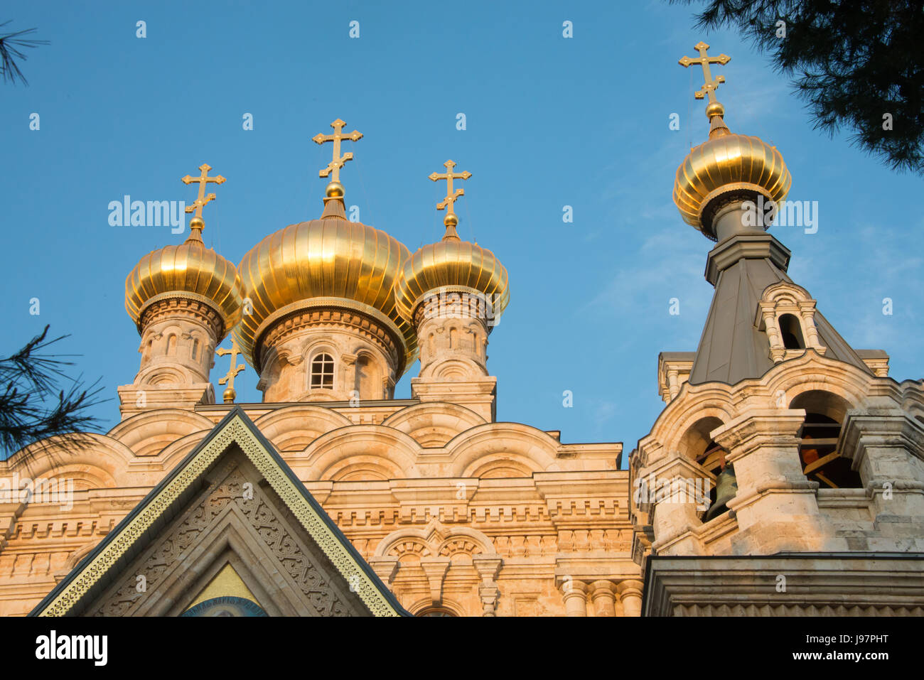 The onion-shaped spires of the Russian Orthodox Church of Mary Magdalene, situated in the Garden of Gethsemane on the Mount of Olives, glow in the evening sun. Jerusalem, April 17, 2014. Stock Photo