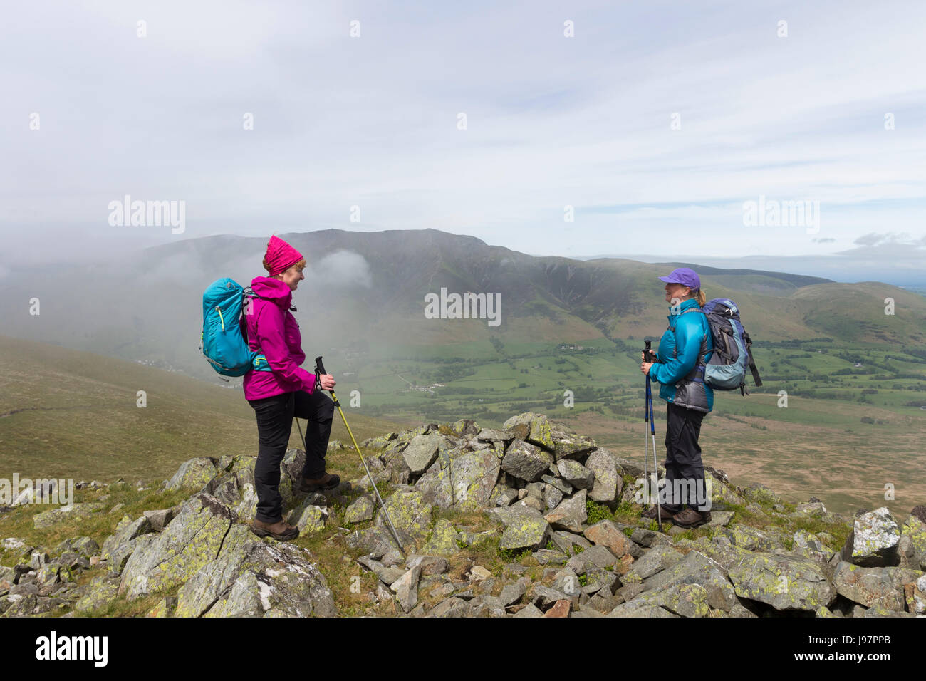 Chatting on White Pike with the Mountain of Blencathra Being Enveloped in Mist, Lake District, Cumbria, UK. Stock Photo