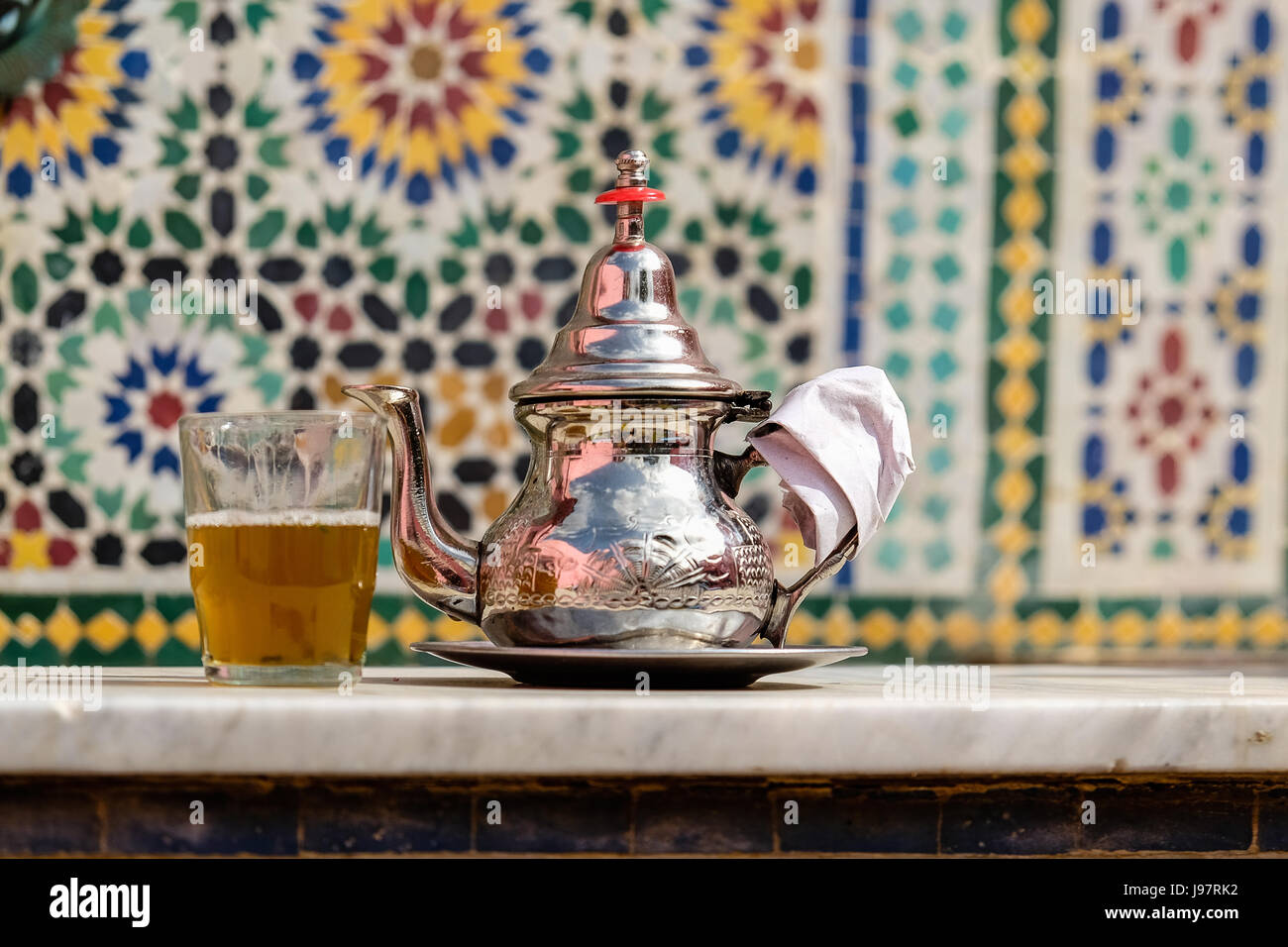 Moroccan teapot against traditional tiles Stock Photo Alamy