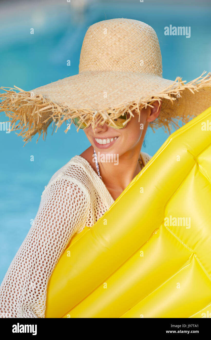 Young happy woman relaxing in a swimming pool Stock Photo