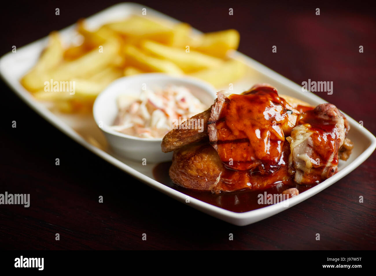 Traditional pub food, chicken in sauce and chips. Stock Photo