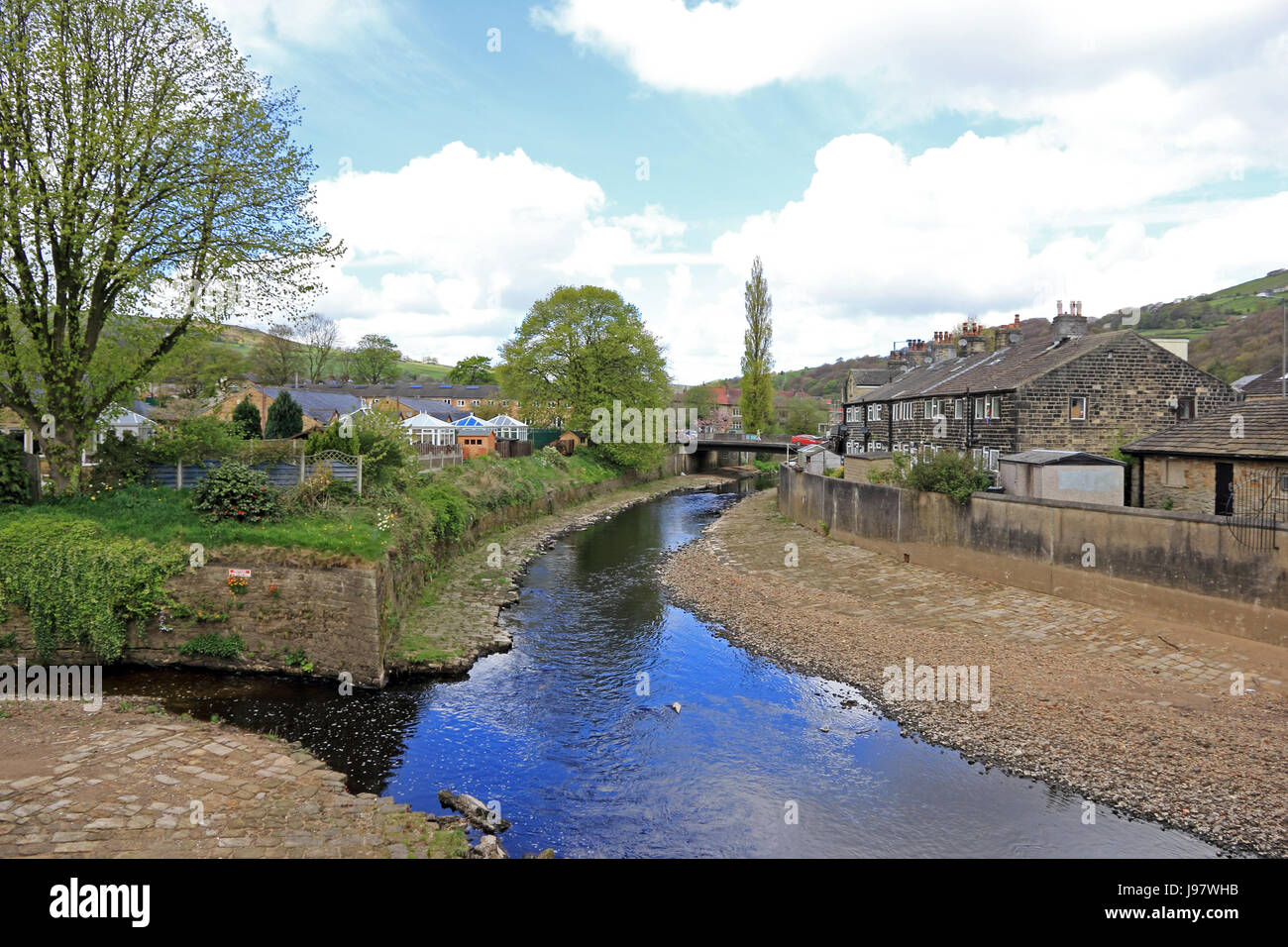 River Calder flowing through village of Mytholmroyd, Calderdale, at point where Cragg Brook feeds into the river. Stock Photo