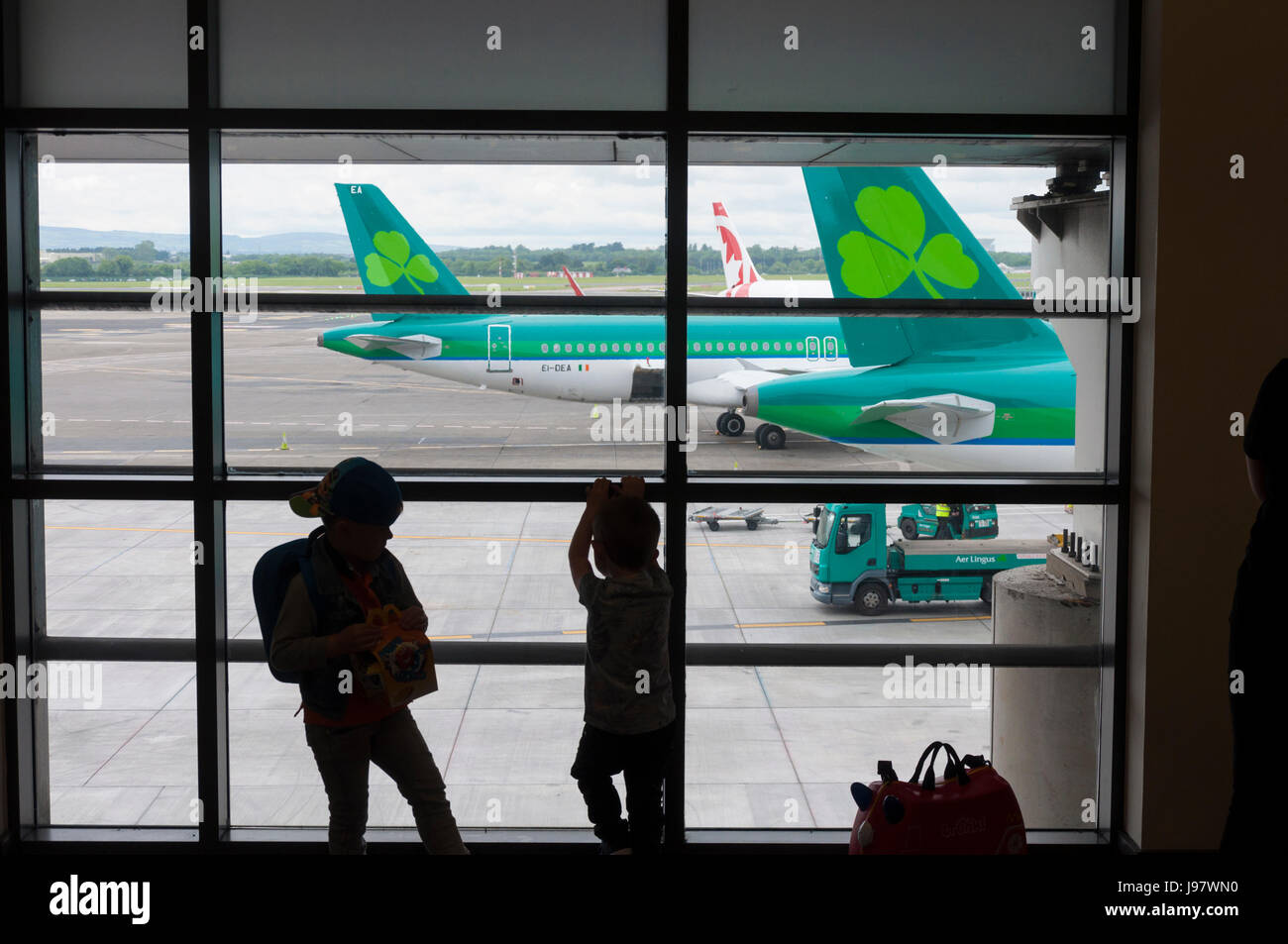 Dublin Airport, Ireland. Children watch aircraft from a terminal one
