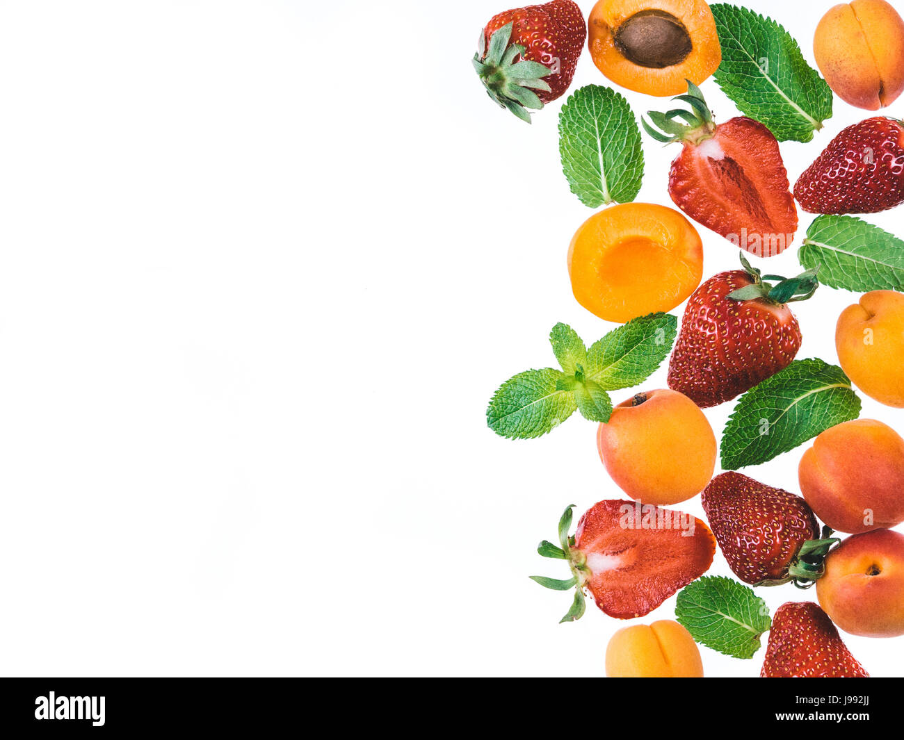Apricot, strawberries and mint leaves isolated on white background with