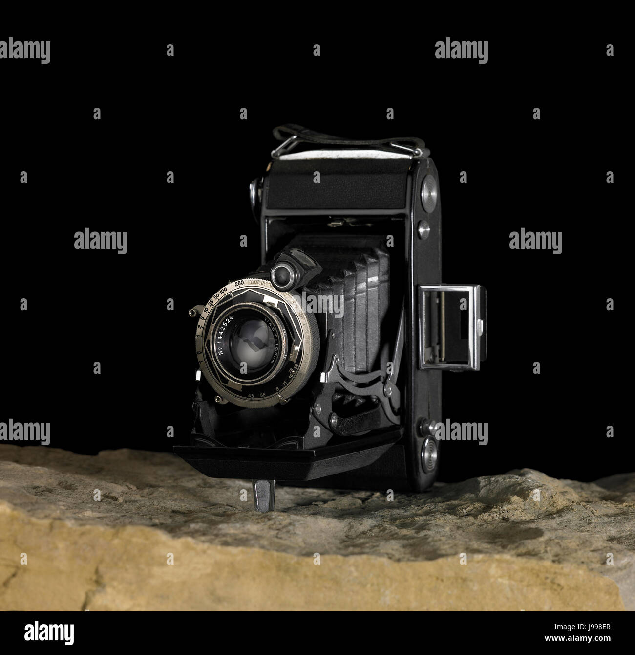 nostalgic camera on stone surface Stock Photo