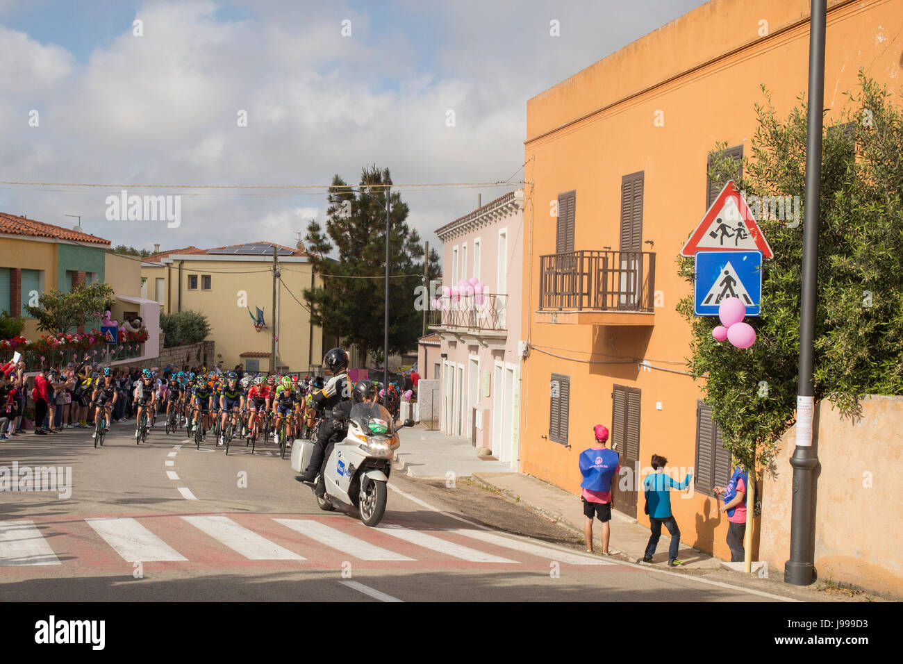 Cyclists pass San Pataleo at the first stage Alghero-Olbia, Giro d'Italia 2017, Sardinia, Italy Stock Photo