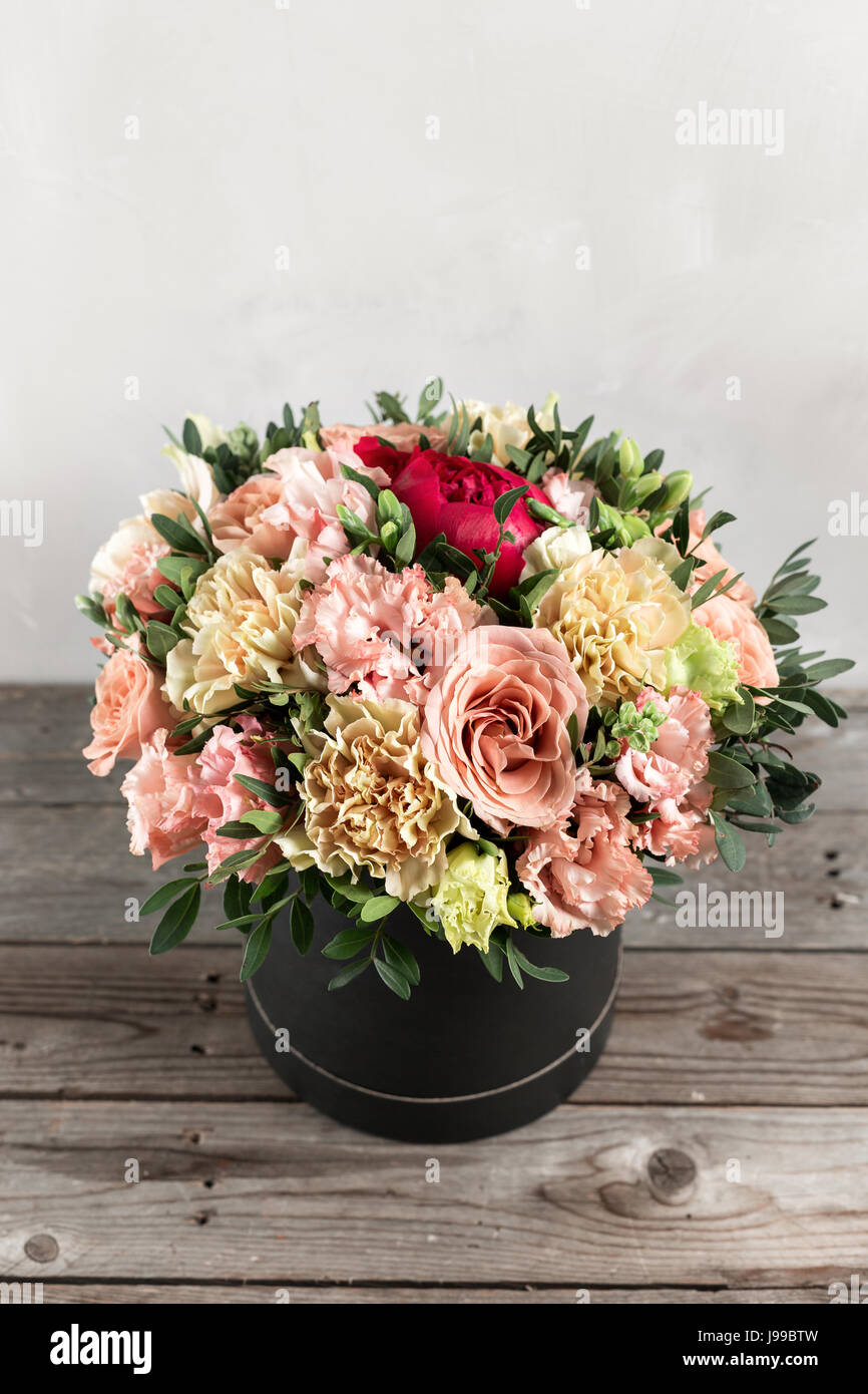 luxurious and elegant bouquet of roses and Other colors flowers on wooden background, copy space. Stock Photo