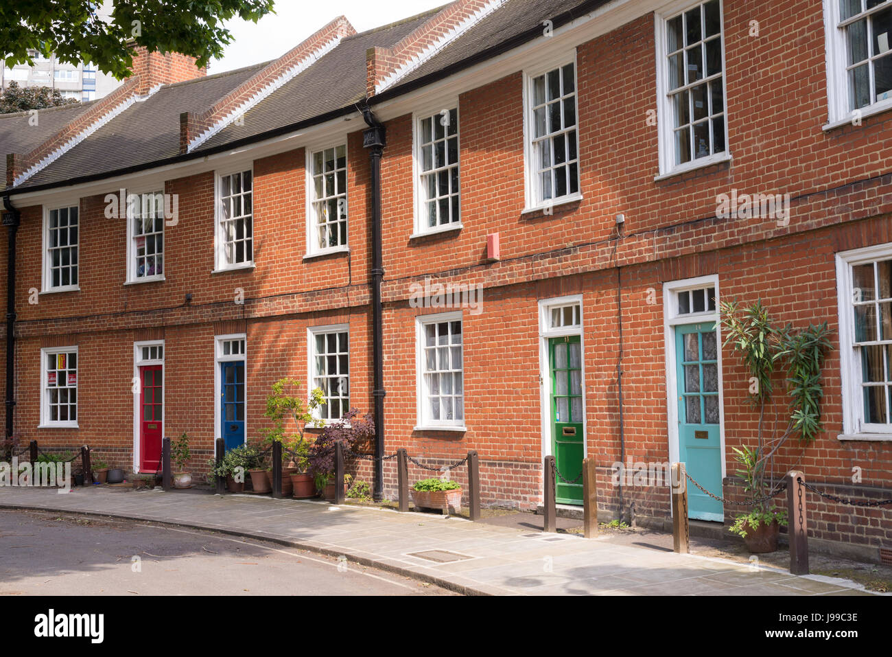 Classic British crescent with restored Victorian red brick houses with  colored doors on a local road in London, UK Stock Photo - Alamy