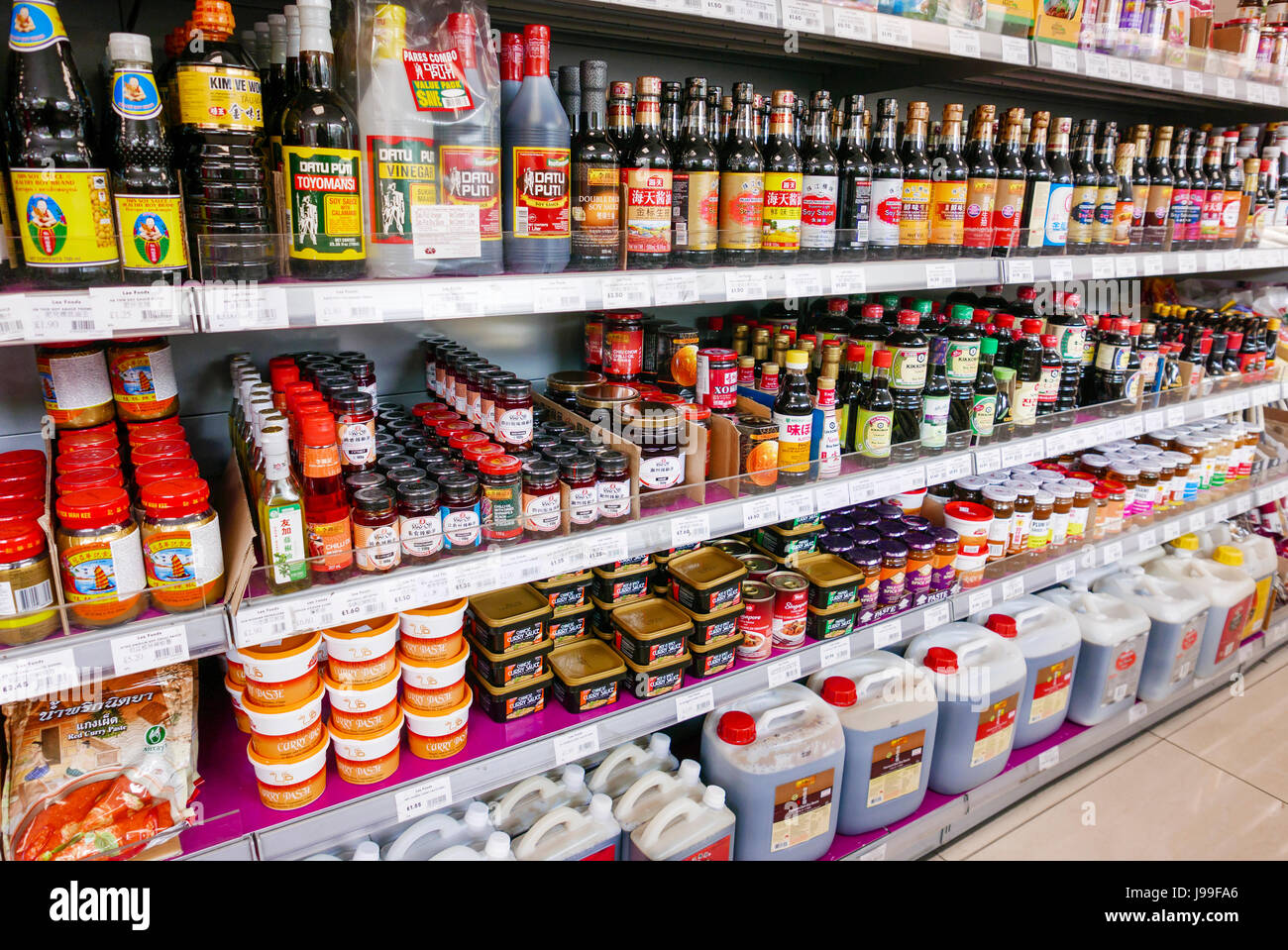 Lots of different varieties and brands of soy sauce in a Chinese Supermarket Stock Photo