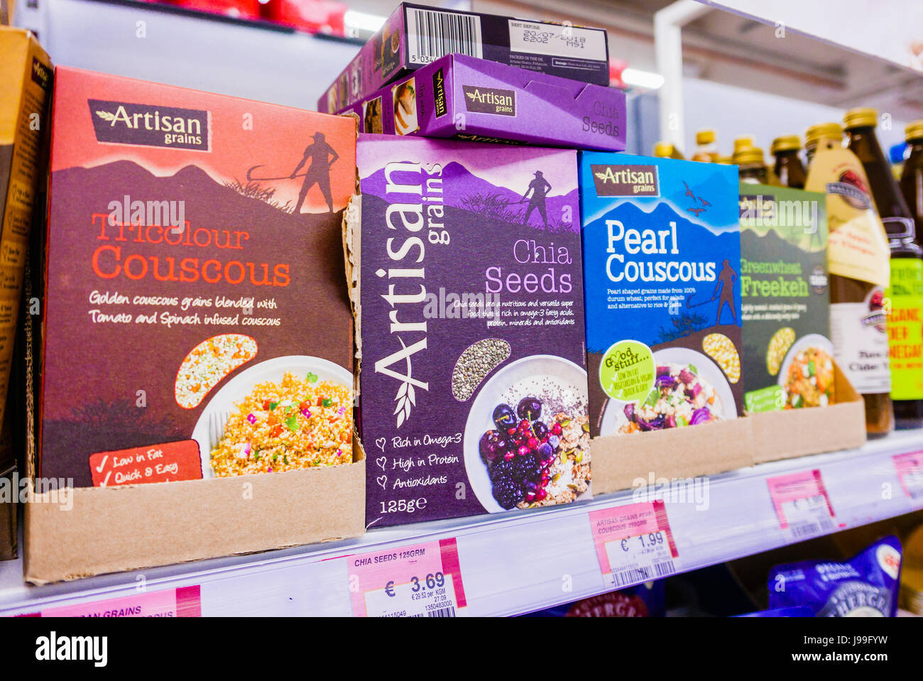 Tricolour couscous, chia seeds, pearl couscous and Freekeh breakfast cereals on the shelf in a supermarket. Stock Photo