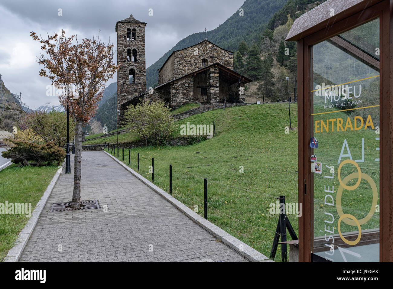 Antique church Sant Joan de Caselles and entrance museum of the motorcycle, Andorra Stock Photo