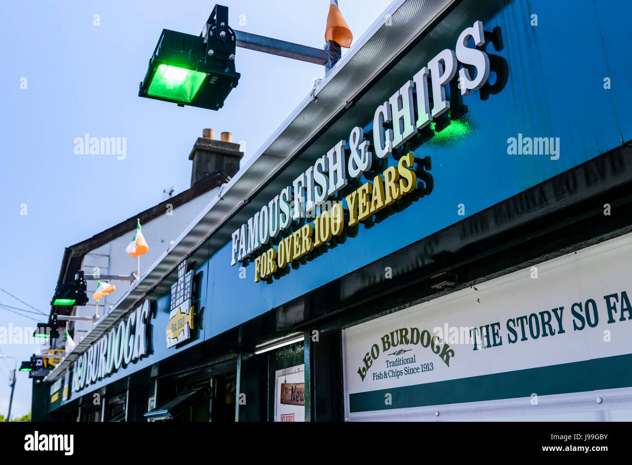 Sign outside Leo Burdock's fish and chip shop in Howth, Dublin, Ireland - 'Famous fish and chips for over 100 years'.  The shop has been visited by do Stock Photo