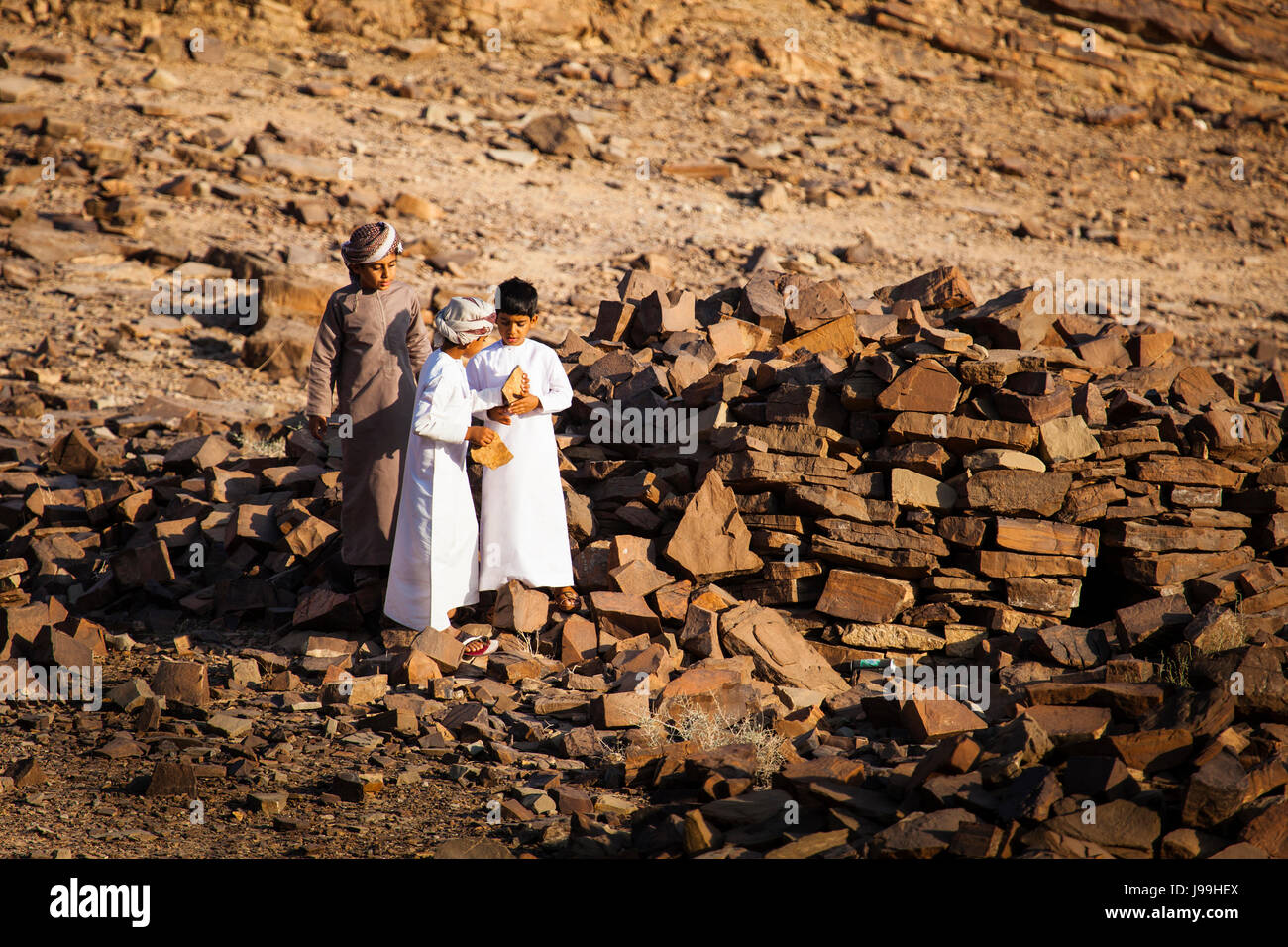 Young boys at Al Ain’s Beehive Tombs, Oman, Arabian peninsula, by Monika Hrdinova/Dembinsky Photo Assoc Stock Photo