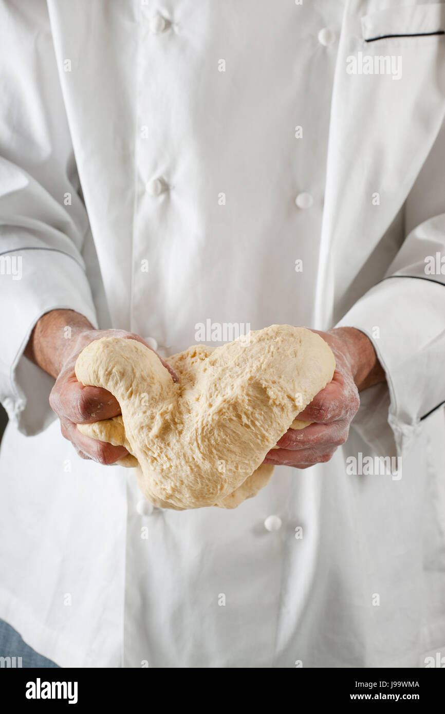 Chef kneading dough, Making dough by male hands at bakery Stock Photo ...