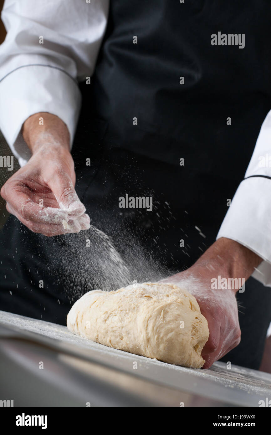 Chef kneading dough, Making dough by male hands at bakery Stock Photo ...