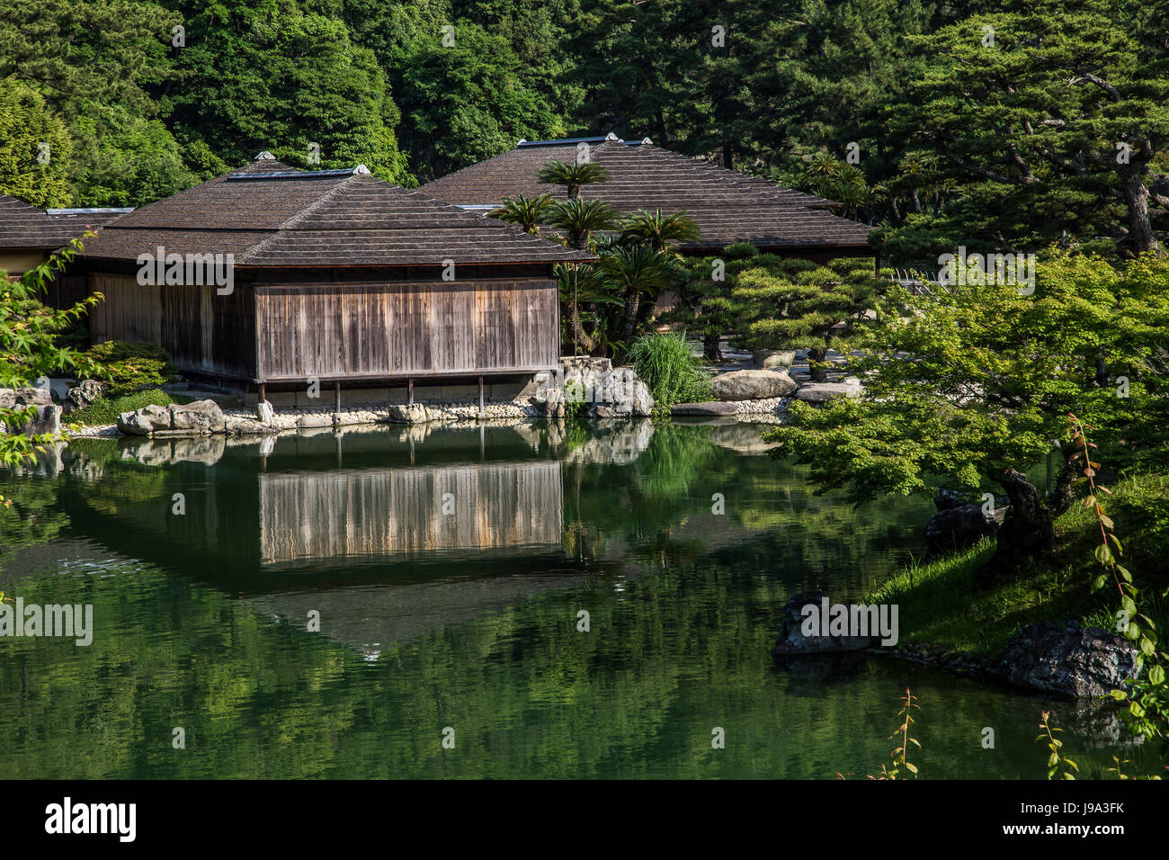 Kikugetsu-tei is a traditional Japanese sukiya teahouse, on the shores of Nanko South Pond, at Ritsurin, one of Japan's most beautiful gardens. Ritsur Stock Photo