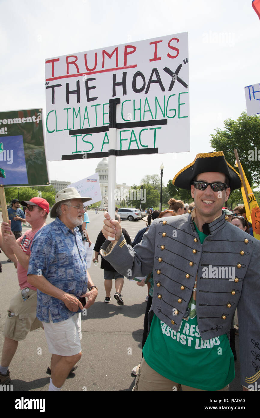 "Trump is the hoax, climate change is a fact" reads the sign. The ...
